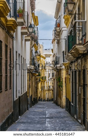 a narrow street in historical center of spanish city cadiz