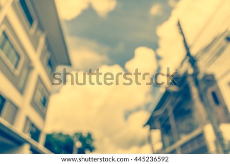 blur image of building in the city for background usage.(vintage tone).