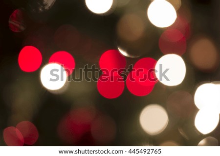 Festive background bokeh of circular red and white party lights in a random pattern for a celebration or holiday event, with copy space.