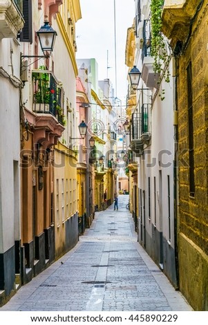 a narrow street in historical center of spanish city cadiz