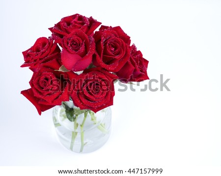 Bouquet red roses flower in glass bottle on isolated / white background