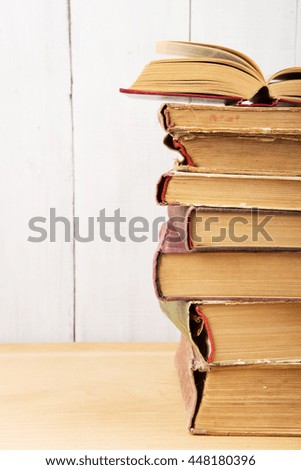 stack of books on the desk over wooden background