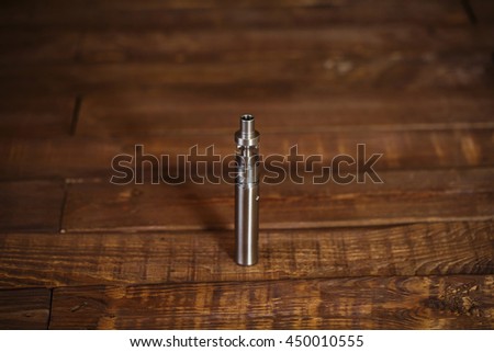 Electronic cigarette on a wooden table. Smoke.
