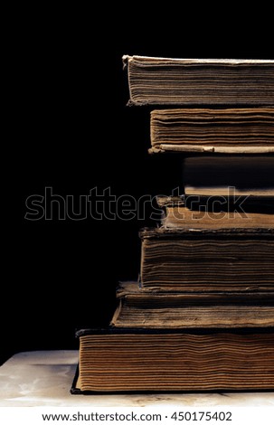 Old books on the black background.