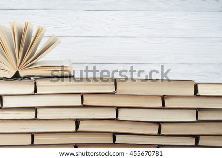 Open book, hardback books on wooden table. Education background. Back to school. Copy space for text