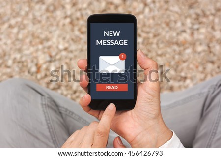 Hands holding smart phone with new message concept on screen. All screen content is designed by me
