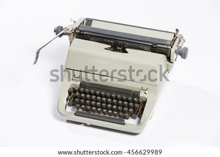 Old fashioned, vintage typewriter isolated on white background with a blank sheet of paper inserted with space for a custom message