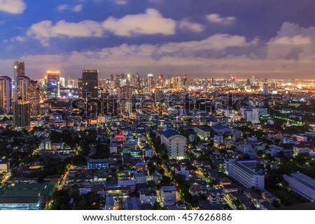 Night light of Bangkok. Panoramic and perspective view light blue background of glass high rise building skyscraper commercial of future. Business concept of success industry tech architecture