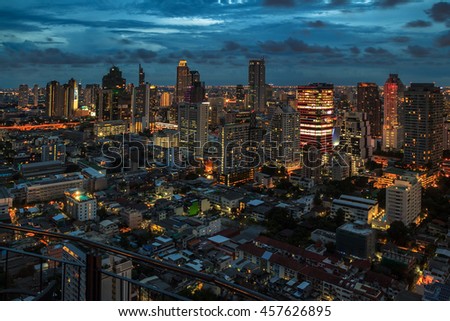 Night light of Bangkok. Panoramic and perspective view light blue background of glass high rise building skyscraper commercial of future. Business concept of success industry tech architecture