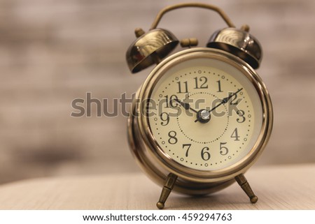 Retro alarm clock on table on office background