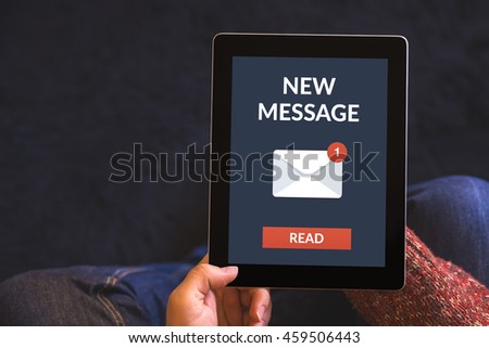 Hands holding digital tablet computer with new message concept on screen. All screen content is designed by me. View from above.
