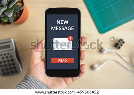 Hand holding smart phone with new message concept on screen. All screen content is designed by me