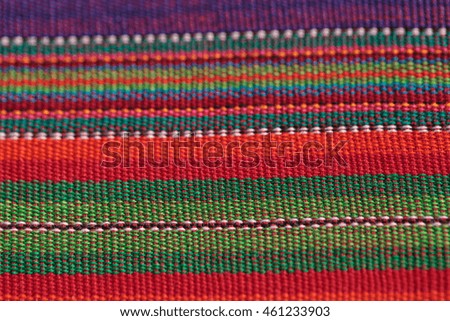 Macro of textured colorful blue, purple, pink, red, yellow and orange fabric background