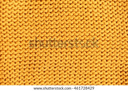 Yellow knitted texture. Wool yarn in knitting background.