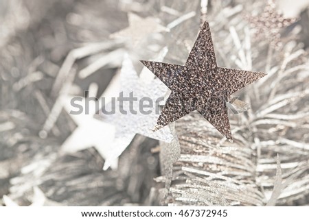 Star tinsel frippery silver garland Christmas background, selective focus
