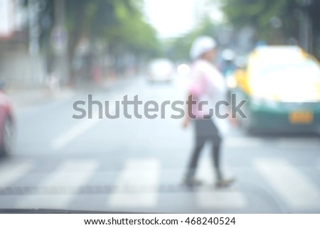 Blurred abstract background and can be illustration to article of People crossing a street crosswalk