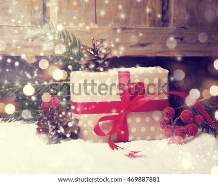 Christmas present on dark wooden background in vintage style