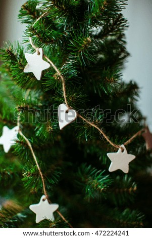 Garland made of white and heart stars hangs around the Christmas