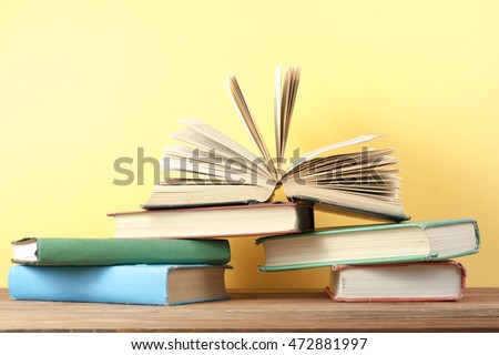 Open book, hardback books on wooden table. Education background. Back to school. Copy space for text.