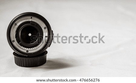 Close up of a prime camera lens against white background. Selective focus