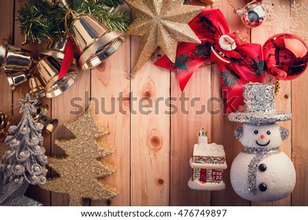 Christmas background with snowman on a rustic wooden board color tone