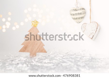 Wooden christmas tree, hanging heart baubles, bokeh, confetti and Neutral colours