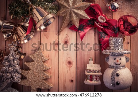 Fir tree branch with christmas lights, gift box and candy canes on wooden background with copy space