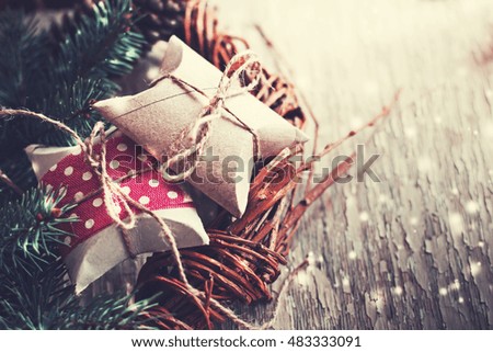 Christmas presents with red ribbon on dark wooden background in vintage style 