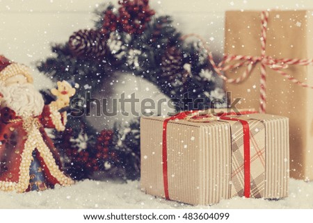 Vintage style Christmas gift boxes in snowing. Shallow focus