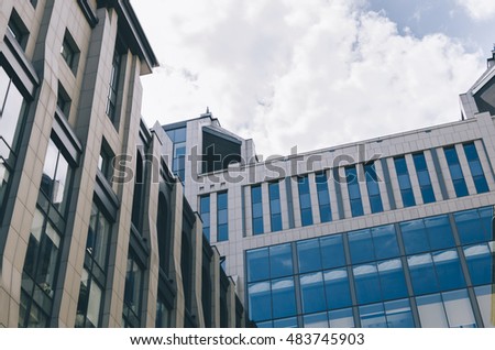 Office building with plate glass walls and gleaming steel structure.