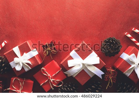 Gift box with white ribbon on red paper background. vintage tone and over light