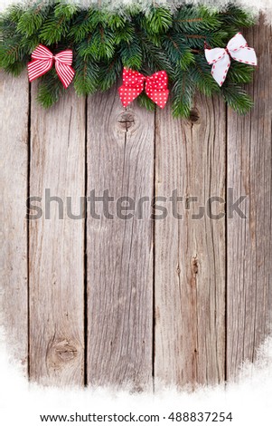 Christmas wooden background with fir tree and ribbon bow. View with copy space for your text