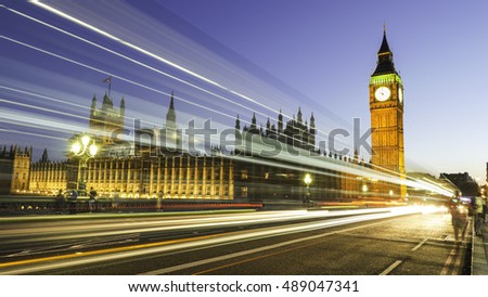 Long exposure picture of the Big Ben and Westminster in London at night with bus and traffic light trails