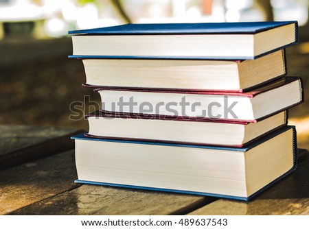 Pile of closed books outdoors