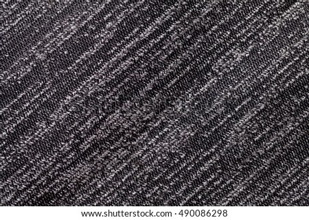 Black and white background of a knitted textile material with diagonal pattern. Fabric with a striped texture closeup.