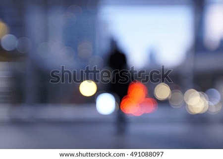 blurry people in urban scene at dusk