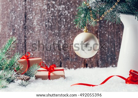 Composition with Christmas decorations in vase on dark wooden background