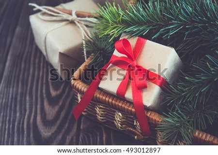 Christmas fir tree with decoration  and gift boxes on dark wooden background