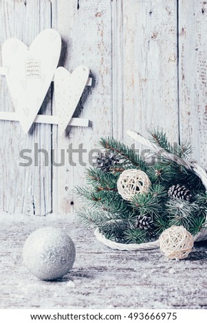 Composition with Christmas decorations in basket, fir tree on wooden background