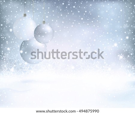 Silver and blue white baubles on a dreamy winter background with light effects and snowfall.