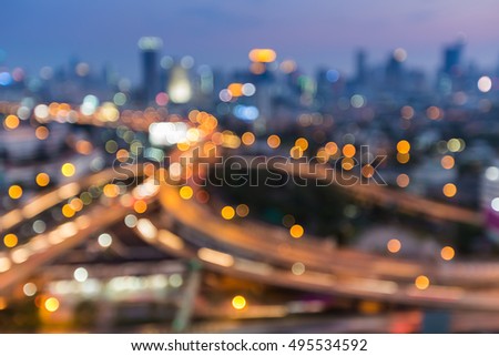 Blurred lights Bangkok highway interchanged with city downtown background, Thailand