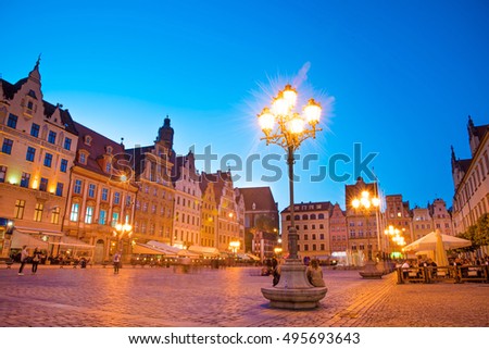 fabulous city landscape with a lantern and fountain on the medieval Market square in Wroclaw (capital of Silesia), Poland, Europe at night. 