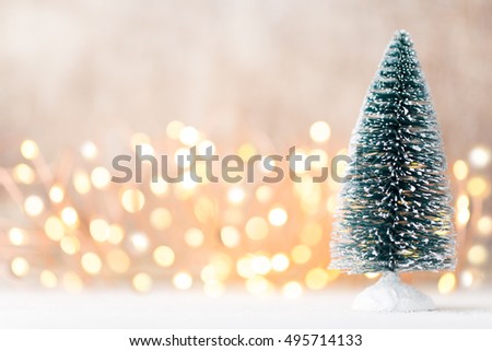 Blur light celebration on christmas tree with wall background.