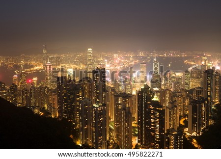 Skyscrapers of Hong Kong in China, Asia. Night view of the city life. Light of the buildings are very colorful, shining with warm tones.