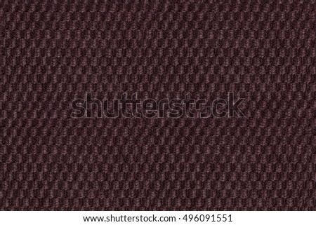 Dark brown background from soft fleecy fabric closeup. Texture of textile macro.