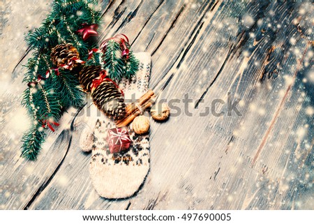 Christmas fir tree with decoration and  copy space on dark wooden board with snowstorm