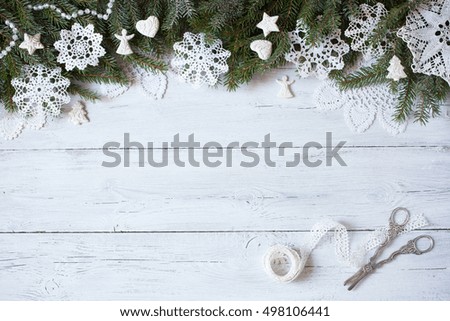 Christmas wooden  white background  with  snowflakes and  tree branches