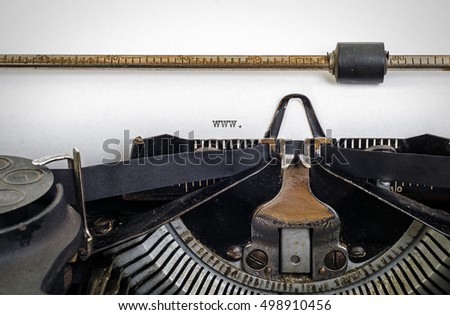 Vintage typewriter with ' www. ' typed onto white paper with copy space.