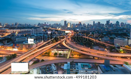 Aerial view twilight sky over city downtown background, highway interchanged, long exposure