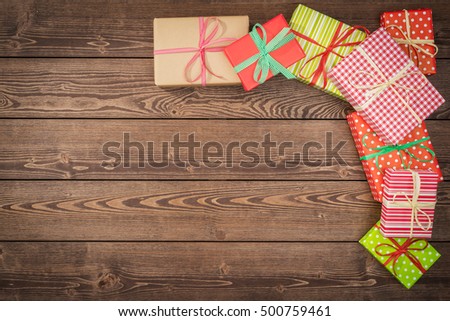 Colorful christmas presents on wooden table